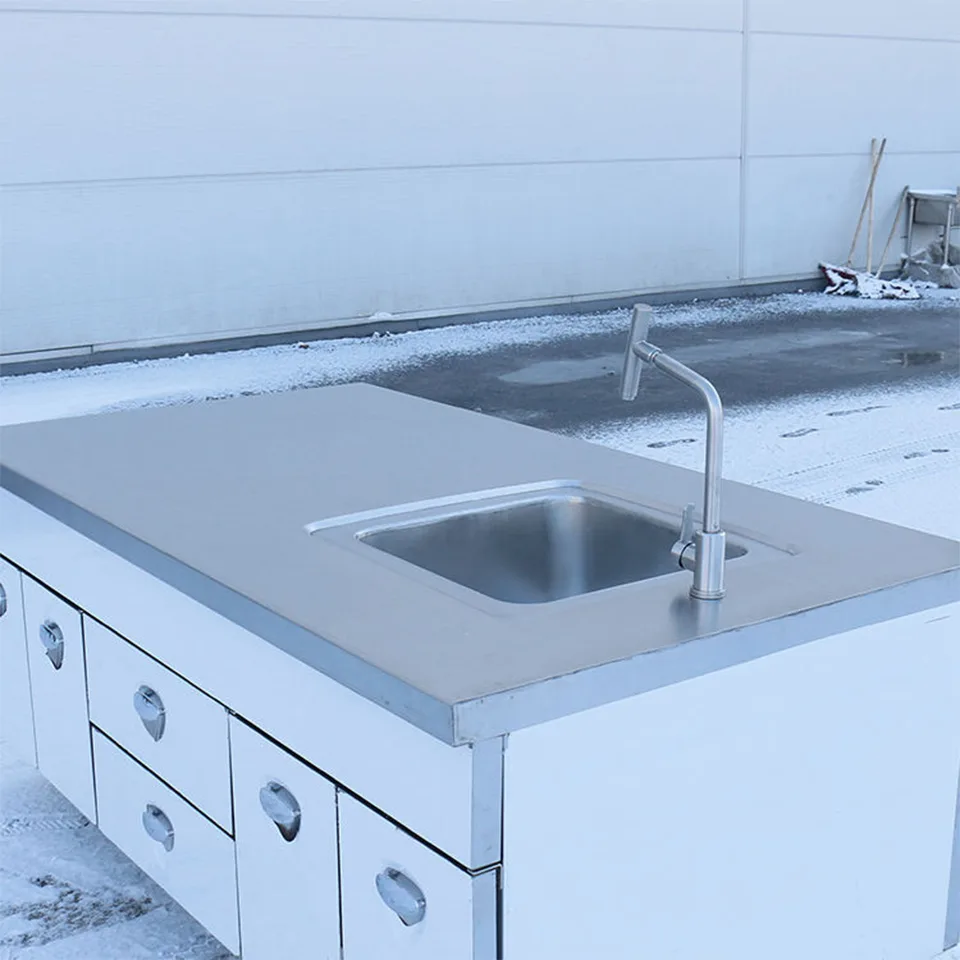 Mesa de trabajo de acero inoxidable con fregadero, armarios y cajones para cocinas comerciales