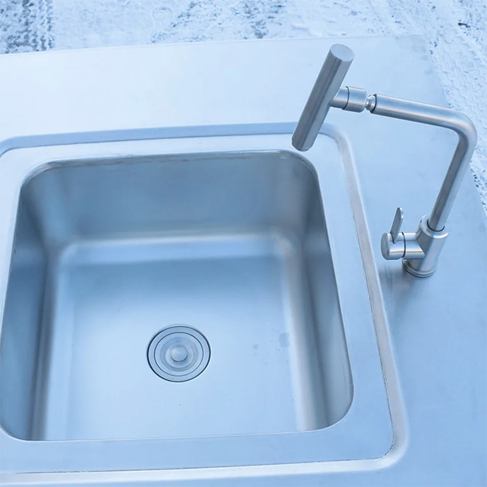 Mesa de trabajo de acero inoxidable con fregadero, armarios y cajones para cocinas comerciales